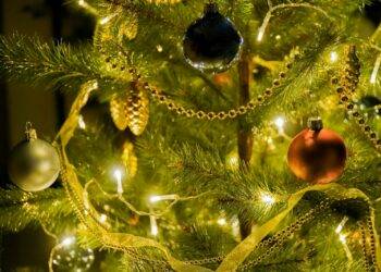 gold and silver baubles on green christmas tree
