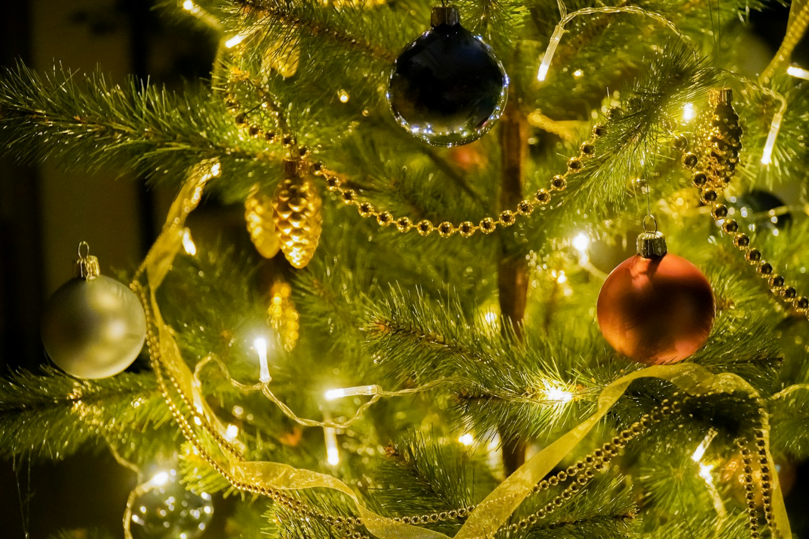 gold and silver baubles on green christmas tree