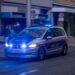 a police car driving down a city street