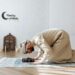 Man in traditional wear kneeling on a prayer rug