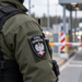 Close-up of a Polish Border Guard officer at a road border checkpoint