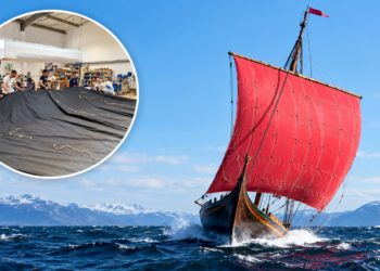 Gdańsk sailmakers working on black sails alongside Draken Harald Hårfagre under a red sail