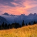Beautiful sunset over the Tatra Mountains with a view of misty peaks and colorful sky.