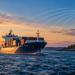 Digital editorial illustration of a cargo ship and coastal radio tower, with illustrative radio-signal arcs suggesting terrestrial ship navigation backup.