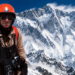 Editorial composite using an authentic photograph of Jerzy Kukuczka with an AI-generated Himalayan mountain background inspired by Lhotse