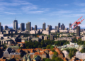 Red aircraft flying above the Warsaw skyline in Microsoft Flight Simulator World Update 23