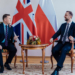 British Defence Secretary Wes Streeting and Polish Defence Minister Władysław Kosiniak-Kamysz in conversation beneath UK and Polish flags. Image source: gov.pl.