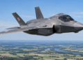 Digitally created illustration of a Polish F-35A Husarz fighter flying above green fields and a river in Poland