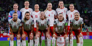 Poland women's football team pose on a football pitch; Ewa Pajor stands in the front row wearing number 9. Photo source: Ewa Pajor / Instagram.