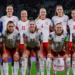 Poland women's football team pose on a football pitch; Ewa Pajor stands in the front row wearing number 9. Photo source: Ewa Pajor / Instagram.