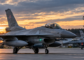 Digitally created editorial illustration of Polish F-16 fighter aircraft on an airbase runway at dawn; not a photograph of the actual military response.
