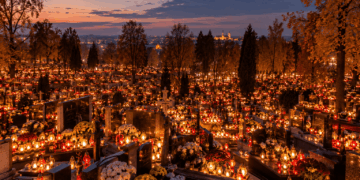 Illustrative view of a Polish cemetery illuminated by memorial candles at dusk