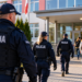 Digitally created editorial illustration of Polish police officers outside a school; not a photograph of a specific school inspection.
