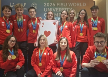 Polish university chess and bridge medal winners wearing red Poland team tracksuits and displaying their medals at the 2026 FISU championship in China.
