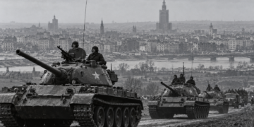 AI-generated editorial illustration of Soviet armoured columns with Warsaw in the background, representing the October 1956 crisis; not an authentic historical photograph
