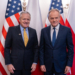 US Ambassador Thomas Rose and Prime Minister Donald Tusk pose together before US and Polish flags at a meeting in Warsaw in December 2025.