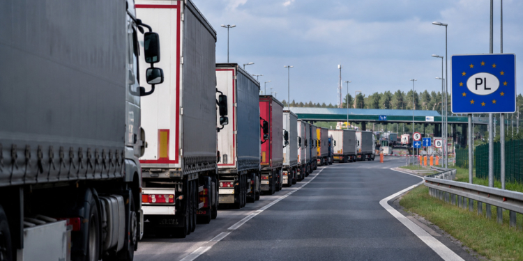 Digitally generated illustration showing a queue of freight lorries approaching a fictionalised Polish border checkpoint.