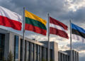 Digitally created illustration of Polish, Lithuanian, Latvian and Estonian flags outside a modern building beneath cloudy skies.