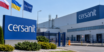 Digitally generated illustrative exterior of a Cersanit-branded factory with Polish and Ukrainian flags; not a photograph of the damaged factory.