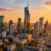 Digitally created Warsaw skyline at sunset, with Varso Tower and the Palace of Culture and Science above the modern financial district.