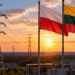 Polish and Lithuanian flags beside electricity transmission infrastructure