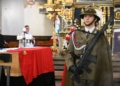 Polish military honour guard beside General Józef Giza's flag-draped coffin in a church during the 2026 reburial ceremony