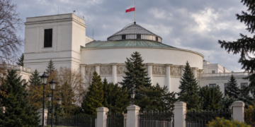 Digitally created architectural illustration of the Polish Sejm parliament building in Warsaw beneath an overcast sky, with the Polish flag flying