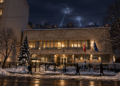 Digitally created night view based on the Polish Embassy in Kyiv, with distant air-defence searchlights over the city