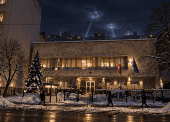 Digitally created night view based on the Polish Embassy in Kyiv, with distant air-defence searchlights over the city