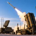 Digitally generated illustration of a missile launching from an air-defence launcher with a Polish flag in the foreground; not a real Narew launch.