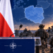 NATO podium beside Polish and NATO flags with a highlighted map of Poland and allied military forces