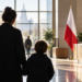 Parent and child in a Polish public-services setting representing proposed care allowance support