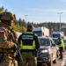 Digitally created editorial illustration of Polish soldiers and Border Guard officers supporting security operations at a border checkpoint