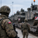 Polish soldiers and military vehicles in a controlled readiness setting
