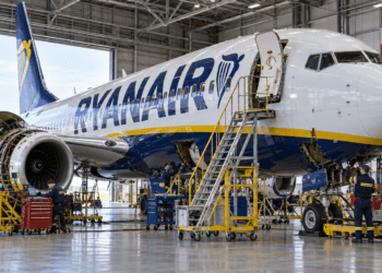 Ryanair Boeing 737 undergoing maintenance in a hangar with a Polish flag in the background