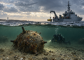Digitally created illustration of a Polish naval mine-clearance operation over a Second World War sea mine in the Baltic