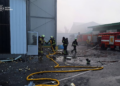 Firefighters and fire engines amid debris and smoke at an industrial site in Ukraine's Volyn region.
