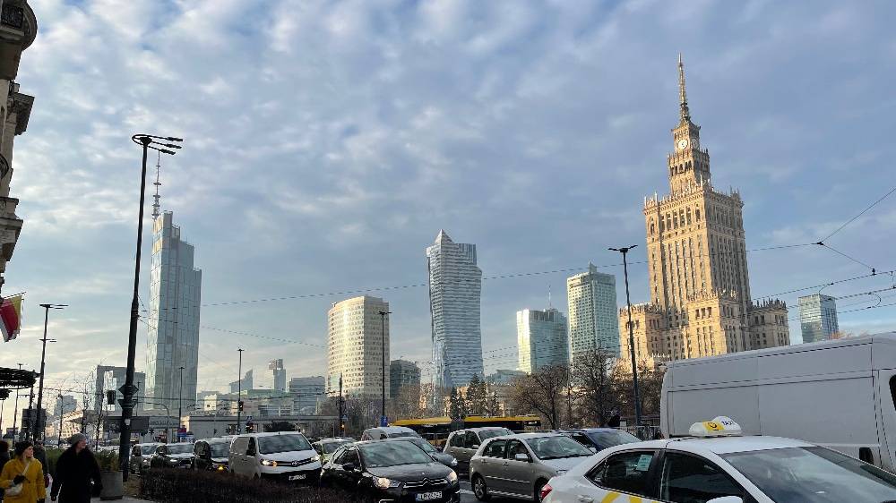 Warsaw skyline showing the Palace of Culture and Science and Varso Tower, photographed in December 2025 by Vikebe (CC0), cropped to 16:9