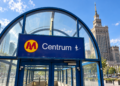 Digitally created illustration of Warsaw Centrum metro station's blue entrance sign and the Palace of Culture and Science behind it under a bright sky.