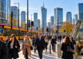 Morning commuters at Rondo Daszyńskiego in Warsaw with trams and the city business skyline