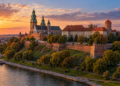 Illustrative sunset view of Wawel Castle on its hill overlooking the Vistula River in Kraków.