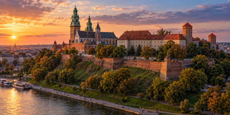 Illustrative sunset view of Wawel Castle on its hill overlooking the Vistula River in Kraków.