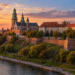 Illustrative sunset view of Wawel Castle on its hill overlooking the Vistula River in Kraków.