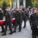 Polish soldiers carry flag-draped coffins during the state funeral for 49 victims of communist repression at Wrocław's Osobowicki Cemetery.