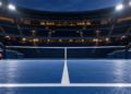 Digitally created illustration of an empty blue hard-court tennis stadium under floodlights, with sports bags and rackets beside the net.
